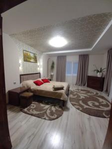 a large bedroom with a bed and a rug at Котедж Тиша in Rivnya +25 photos