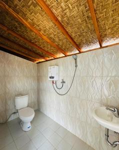 a bathroom with a toilet and a shower at Pinggan Campside Glamping in Baturaja +59 photos