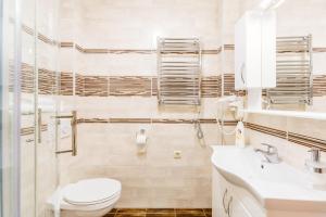 a white bathroom with a toilet and a sink at Kotor Luxury View in Kotor +16 photos