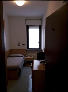 Postel nebo postele na pokoji v ubytování Hotel Cristallo
