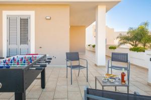 a table and chairs and a chessboard on a patio at Villa di Punta, Leuca - by HDSalento in Leuca