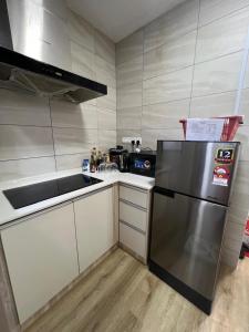 a kitchen with a stainless steel refrigerator and a sink at Jin Lin Homestay 1 in Sibu