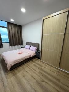 a bedroom with a bed and a large sliding glass door at Jin Lin Homestay 1 in Sibu