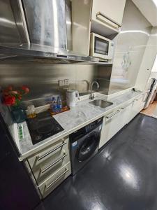 Kuchyň nebo kuchyňský kout v ubytování 广州友家国际酒店公寓 + 15 fotografií