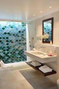 a bathroom with a sink and a glass shower at Cal Reiet Holistic Retreat in Santanyi