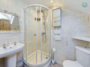 a bathroom with a shower and a toilet and a sink at Sea Salt - Beer, East Devon in Beer +9 photos