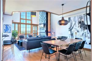 a living room with a table and a couch at Exclusive Mountain Home With View - Equinoxe 164-2 in Mont-Tremblant