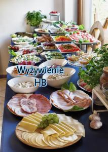 a long table with many plates of food on it at Willa Kapitańska i Willa Marynarska in Łeba