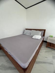 a bed in a white room with a mattress at Xavier's Place Coron in Coron
