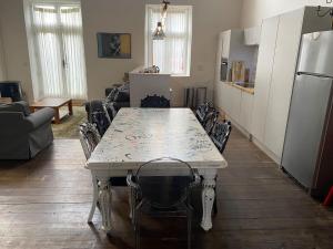 a kitchen with a white table and chairs in a room at Norfolk Chapel hideaway in Briston +22 photos