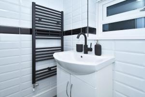 a white bathroom with a sink and a window at Townhouse @ 42 Minshull New Road Crewe in Crewe