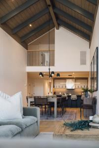 a living room with a couch and a dining room at Verbier 6-203 Family Luxury Retreat in Mont-Tremblant