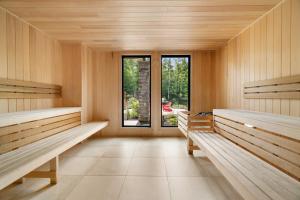 a sauna with wooden benches and a window at Verbier 6-203 Family Luxury Retreat in Mont-Tremblant +33 photos