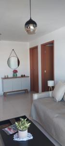 a bedroom with a bed and a table and a mirror at Village - Cond Planeta Água - Jacuípe in Barra de Jacuípe +23 photos