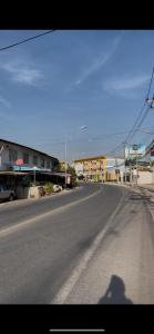 a shadow of a person walking down a street at CozyHouse Korat in Sathani Phu Khao Lat +6 photos