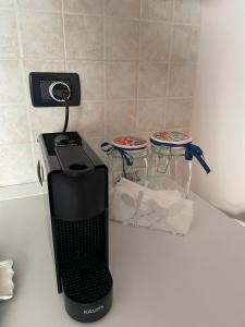 a black appliance sitting on top of a counter at Appartamento ' Il sole di Vale' in Loano