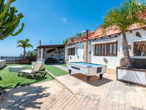 a pool table in the backyard of a house at Arico Cave Experience in Arico
