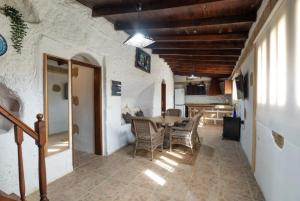 a kitchen and dining room with a table and chairs at Arico Cave Experience in Arico