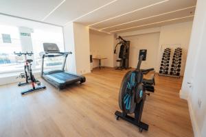 a gym with bikes and exercise equipment in a room at Amérian Córdoba Park Hotel in Córdoba