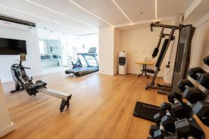 a gym with treadmills and machines in a room at Amérian Córdoba Park Hotel in Córdoba