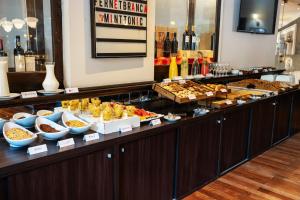 a buffet line with many different types of food at Amérian Córdoba Park Hotel in Córdoba
