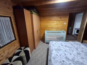 a bedroom with a bed and a dresser in a room at Drinska Ljepotica in Bijeljina +34 photos