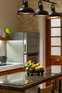 a kitchen with a table with a plate of food at Casa Laurel 1 in Mérida
