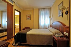Postel nebo postele na pokoji v ubytování Hotel Alisi + 17 fotografií