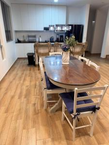 a dining room table with chairs and a table with flowers on it at Casa de Playa - Asia - SELENE beach house in Asia