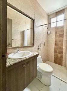 a bathroom with a sink and a toilet and a mirror at Las Casitas en Santa Elena in Santa Elena