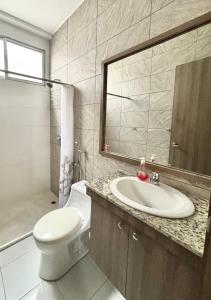 a bathroom with a sink and a toilet and a mirror at Las Casitas en Santa Elena in Santa Elena +5 photos