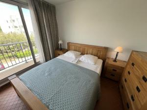 a bedroom with a bed and a large window at Sol-y-Days Belles Plages, front de mer avec piscine in La Grande Motte +15 photos