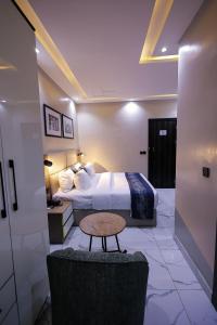 a hotel room with a bed and a table at Ringruby Hotel, Oduduwa Way in Ikeja