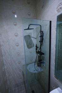 a bathroom with a shower with a sink at Ringruby Hotel, Oduduwa Way in Ikeja