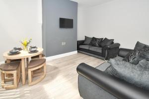 a living room with a couch and a table at Townhouse @ Lawton Street Crewe in Crewe