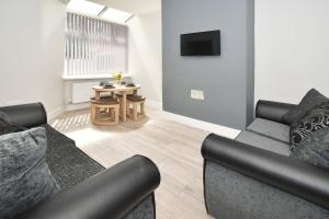 a living room with a couch and a table at Townhouse @ Lawton Street Crewe in Crewe