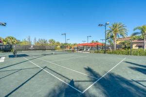 a tennis court with a net on top of it at Live in Paradise with Golf Tennis Gym Pools and More! in Bonita Springs