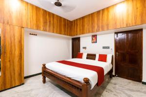 a bedroom with a large bed with wooden walls at Sri Balaji Villas Pondicherry with Car Parking in Pondicherry