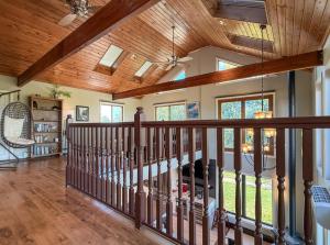a staircase in a house with wooden ceilings at Elyon Hall Coach House in Gary +60 photos