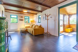 a living room with a couch and a table at Cozy cottage Geltschberg Nr. 1 in Liběšice