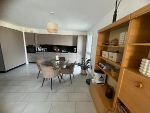 a kitchen and dining room with a table and chairs at Apartment Martigny in Martigny-Ville