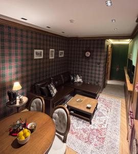 a living room with a couch and a table at Apartment25 Poljice Apart Hotel Jahorina in Jahorina