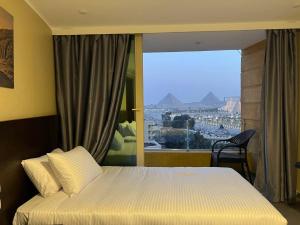Voodi või voodid majutusasutuse Asia Pyramids View toas