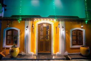 a house with a front door with christmas lights at Sri Balaji Villas Pondicherry with Car Parking in Pondicherry