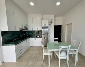 a kitchen and dining room with a table and chairs at Las Casitas - Milina in Salinas