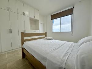 a bedroom with a large bed and a window at Las Casitas - Milina in Salinas