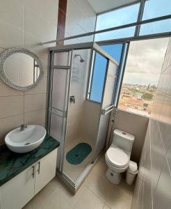 a bathroom with a shower and a toilet and a sink at Las Casitas - Milina in Salinas