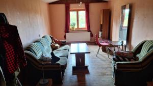 a living room with two couches and a table at Pensjonat Stara szkoła in Piaseczno +27 photos