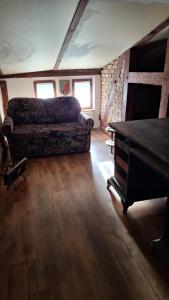 a living room with a couch and a piano at Pensjonat Stara szkoła in Piaseczno