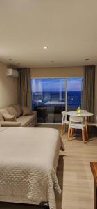 a bedroom with a bed and a view of the ocean at Quequen - Vista al Mar in Quequén